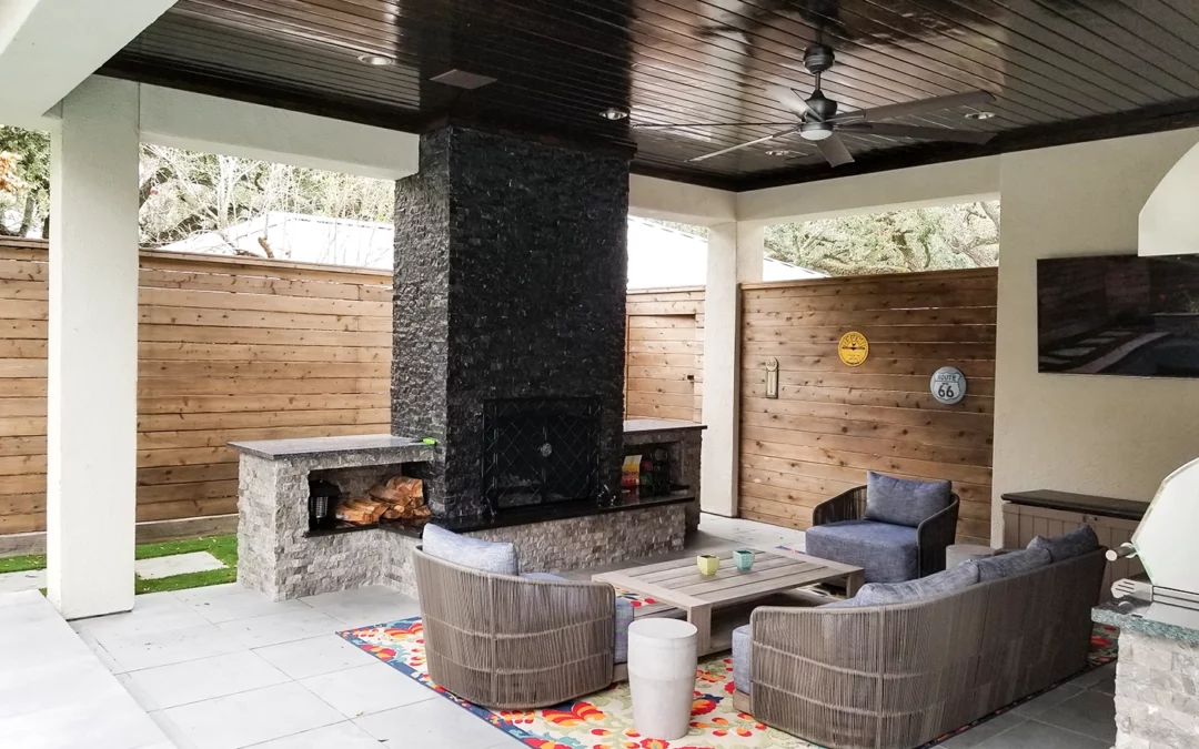 a covered patio with outdoor fireplace